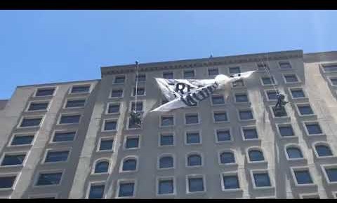 Activists rappel off building to drop giant banner for #FreeOurFuture San Diego Day of Action 7/2